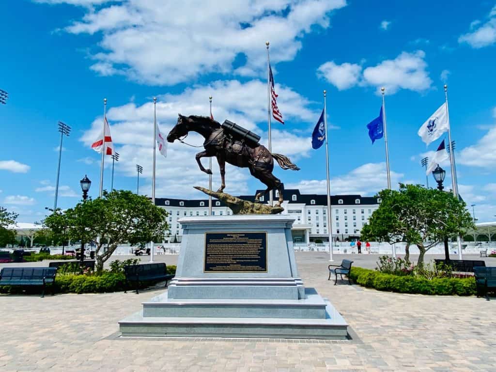 World Equestrian Center Ocala - Statue of a horse photo.  The flags fly behind it, and you can see the Equestrian Hotel in the distance.