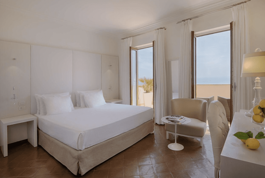 NH Collection Grand Hotel Boutique Hotels Amalfi Coast. It has warm colored floors with white linen and beautiful views.