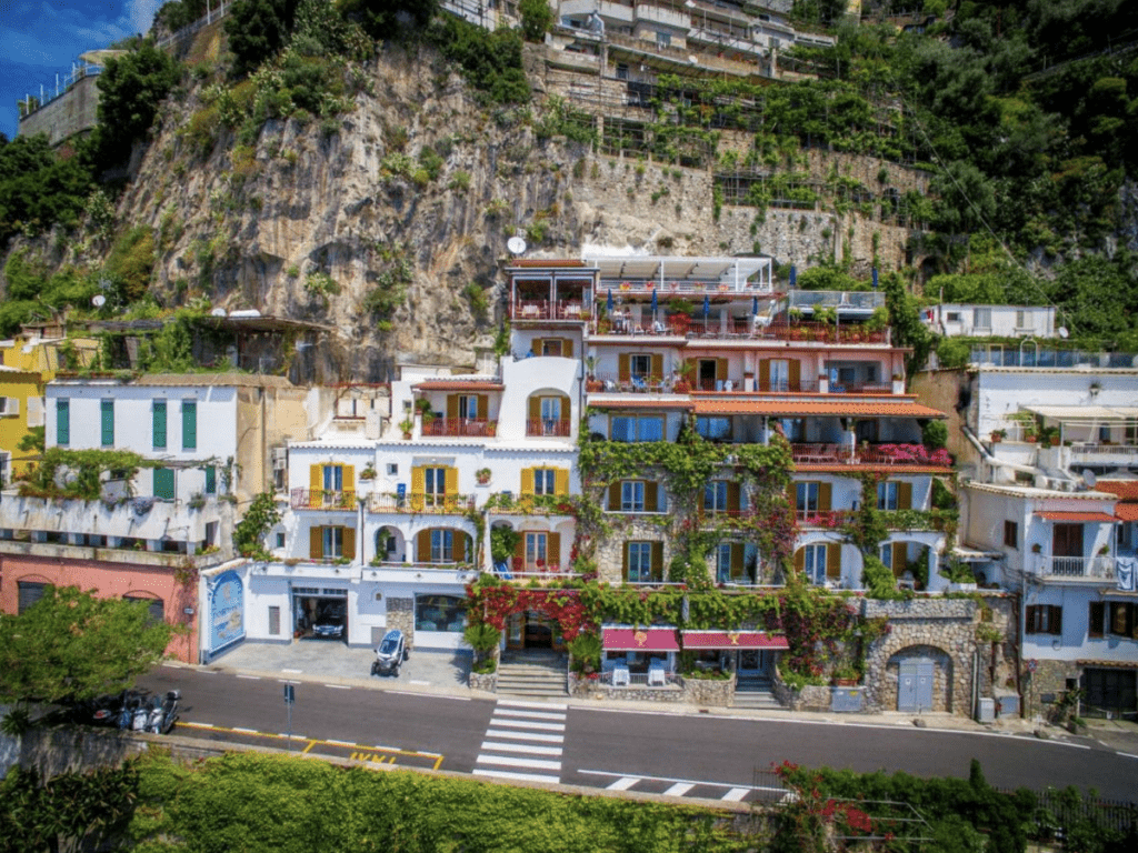 Boutique Hotels Amalfi Coast, Hotel Eden Roc Suites, Positano.  The hotel sits perched on a cliff with colorful windows and decor.  