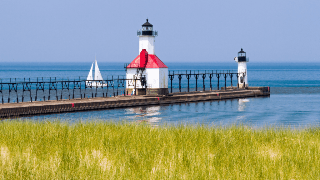 St. Joseph lighthouse and sailing boat in the distance.