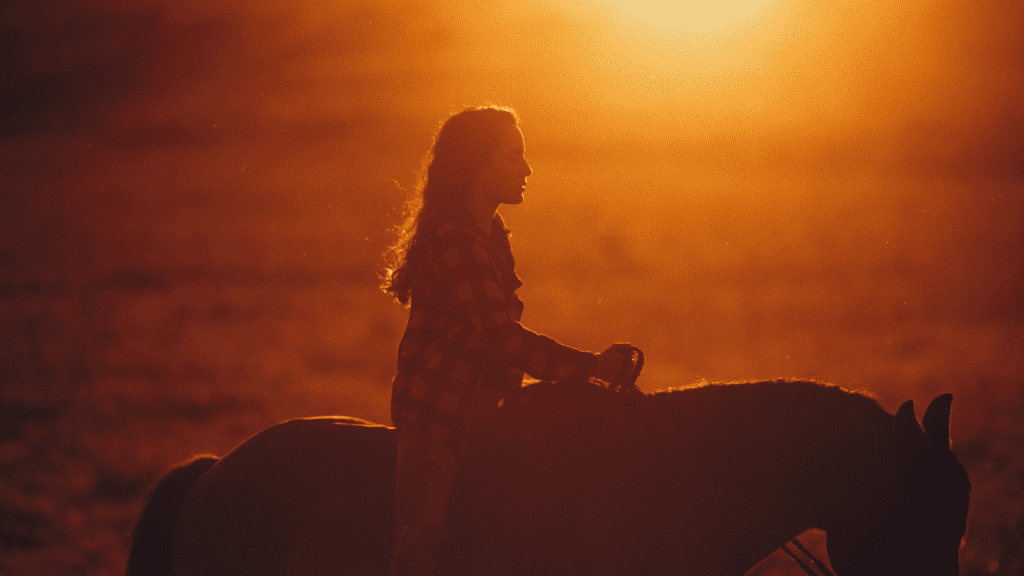 Horseback riding photo at sunset.