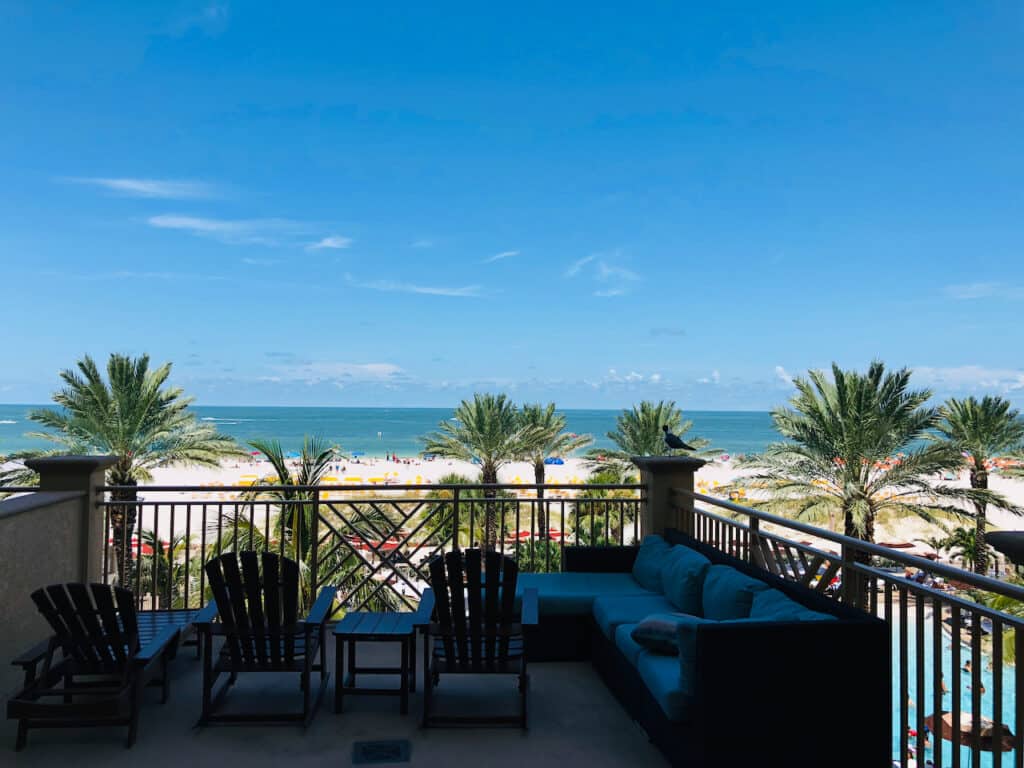The Sand Pearl Resort in Clearwater Beach, FL has large balcony view of the white sandy beaches and pool.