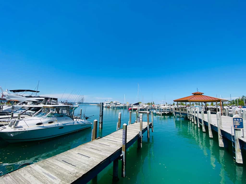 elk rapids marina with a photo of grand traverse bay and boats.