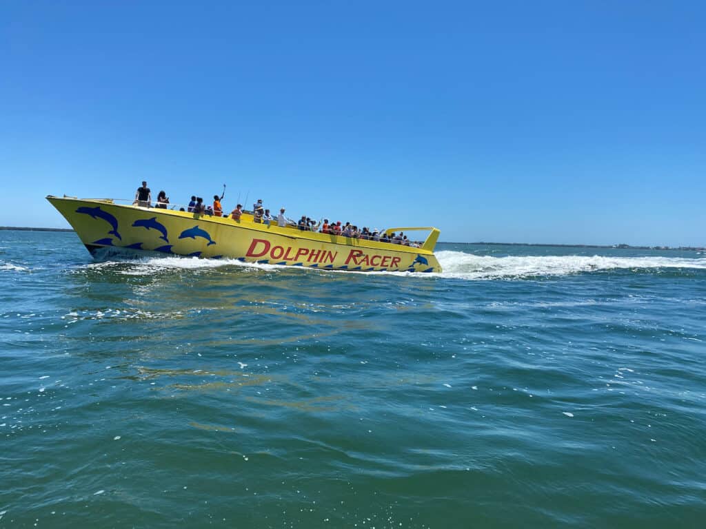 Dolphin Racer Tours is one of the fun things to do in St Pete Beach.  Photo was taken from water with the boat racing.