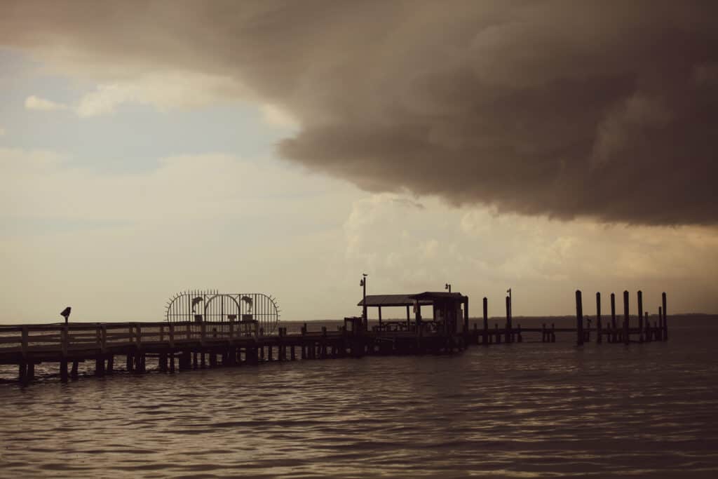 Dark clouds and the pier in the distance.  Bookelia Fishing Piers is one of the fun things to do on Pine Island, Florida.