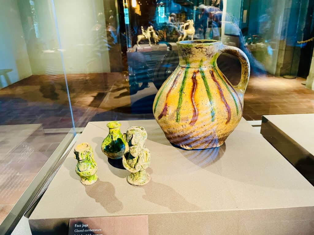 Face Jugs, Glazed Earthware green with face shapes in the Cloisters NYC