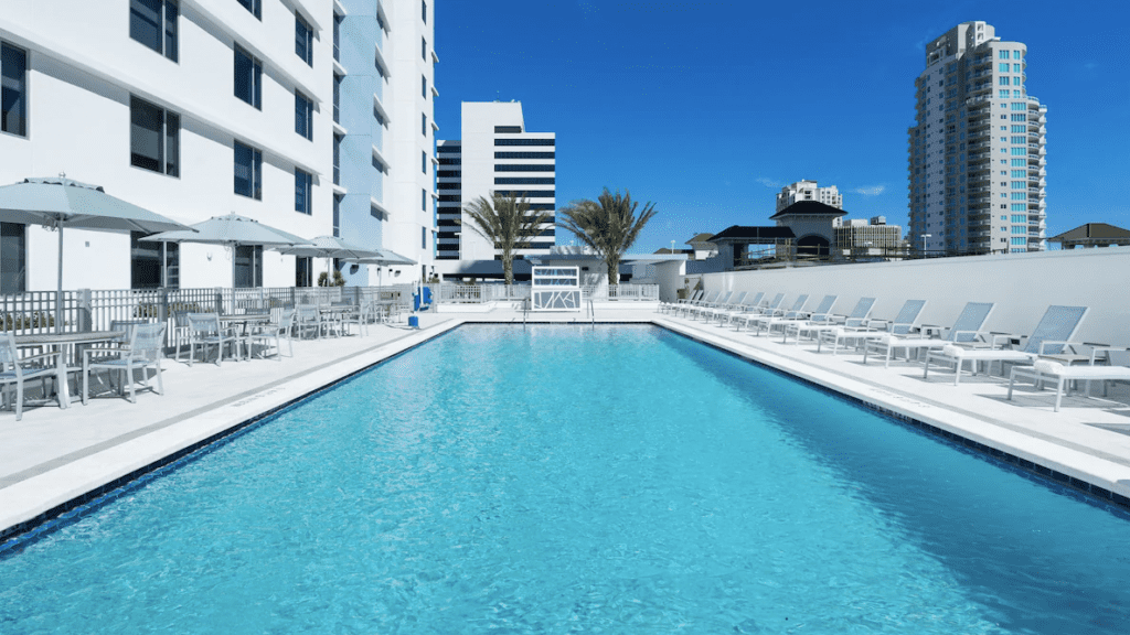 Photo of the Hyatt Place St Petersburg Downtown Hotel and pool area.  It's elevated with highrises around it. 