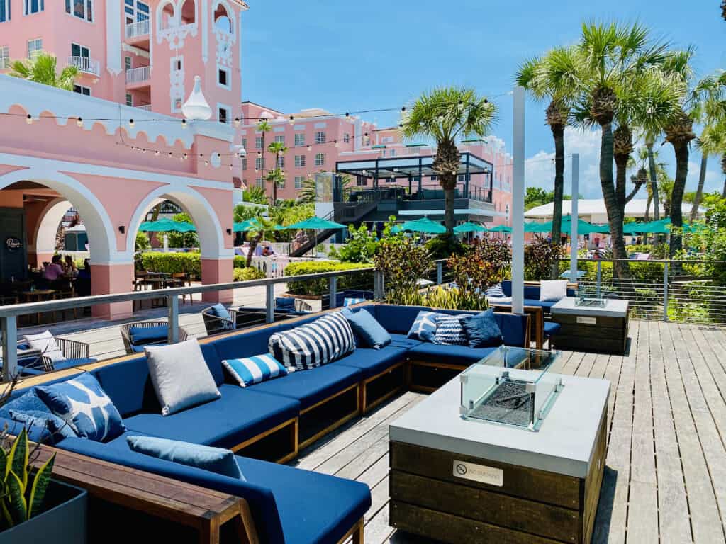 The pink palace otherwise known as The Don CeSar has been lounge chairs and seating near the pool area with fire pits. The photo shows the expanding outdoor area with many things to do at this St Pete Spring Break Hotel.