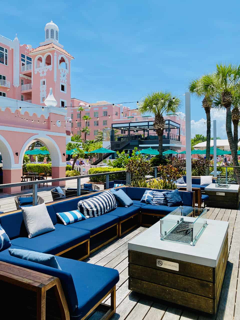 Fire pit and lounge chairs by the pool bar at Don CeSar