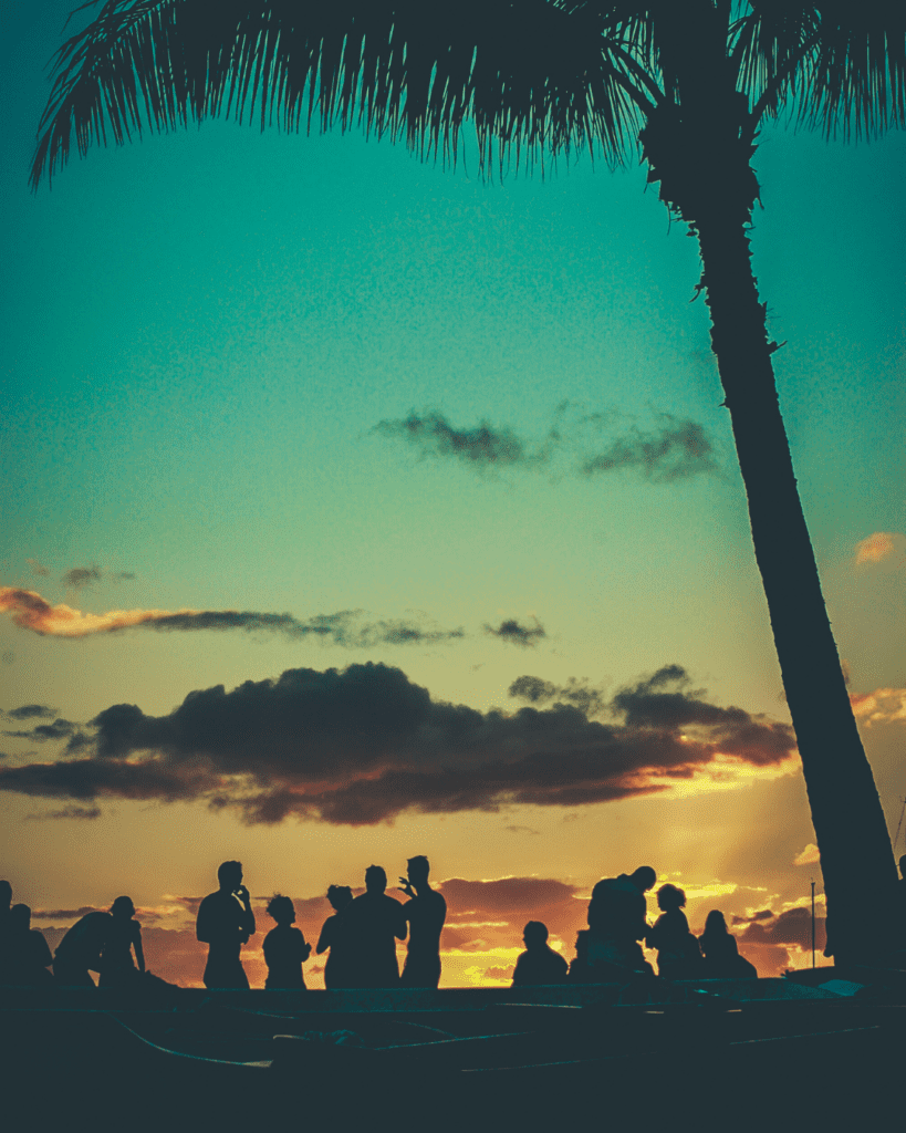 Party vibes on st pete beach with a sunset in the background with a crowd.