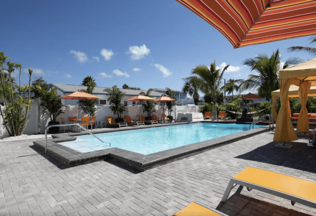 The Villas at St Pete Beach Pool photo with hammock, cabanas, as pool chairs.