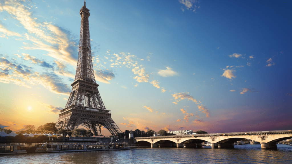 While there is no snowboard in paris you get amazing views from the river of the Eiffel tower at sunset as seen here with blue pink and yellow sky.