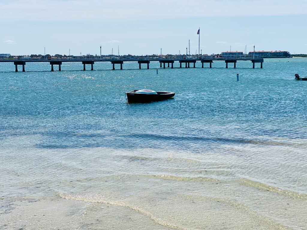 Gulfport, FL has beautiful views of Boca Ciega Bay and has free boat docks available. Showing a boat parked next to the dock.