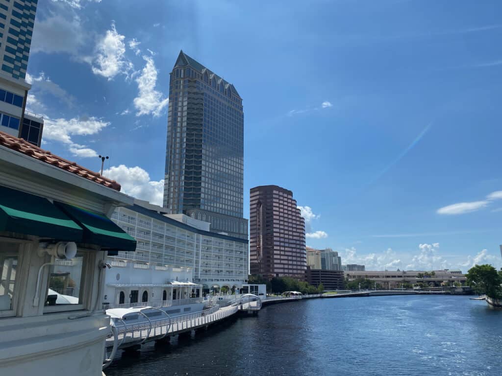Photo of the Tampa Riverwalk and Hillsborough River during the day.  The Tampa Christmas Boat Parade will come through these waterways.