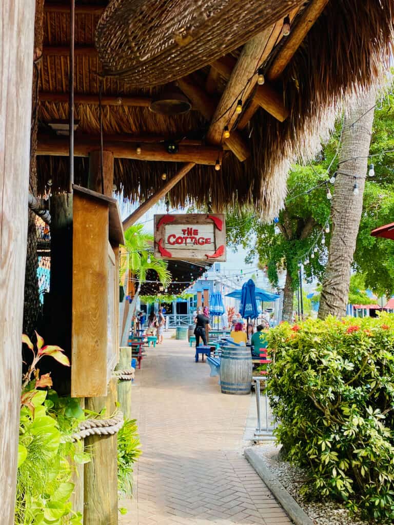 The Cottage Restaurant entrance with tiki beach vibe in Siesta Key Village