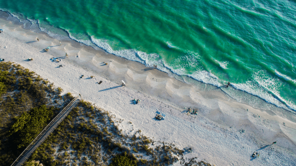 Ariel photograph of Treasure Island and the Gulf of Mexico with green water and sandy beaches.  