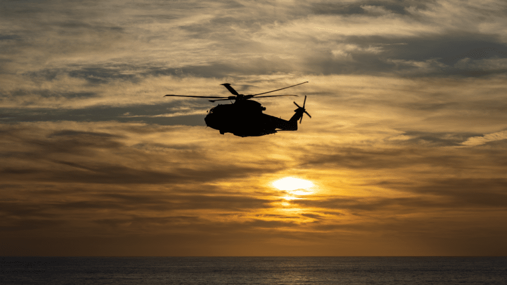 Helicopter flying over sunset with waterfront