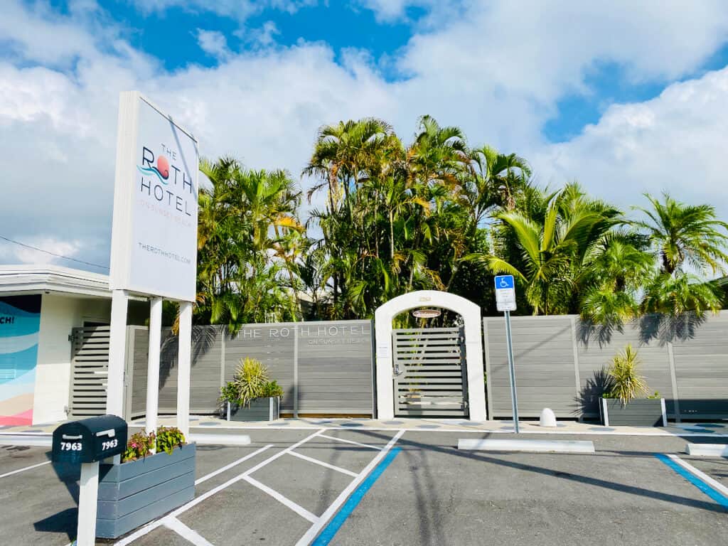 The Roth Hotel in Sunset Beach view of the outside with beautiful gates and palm trees.