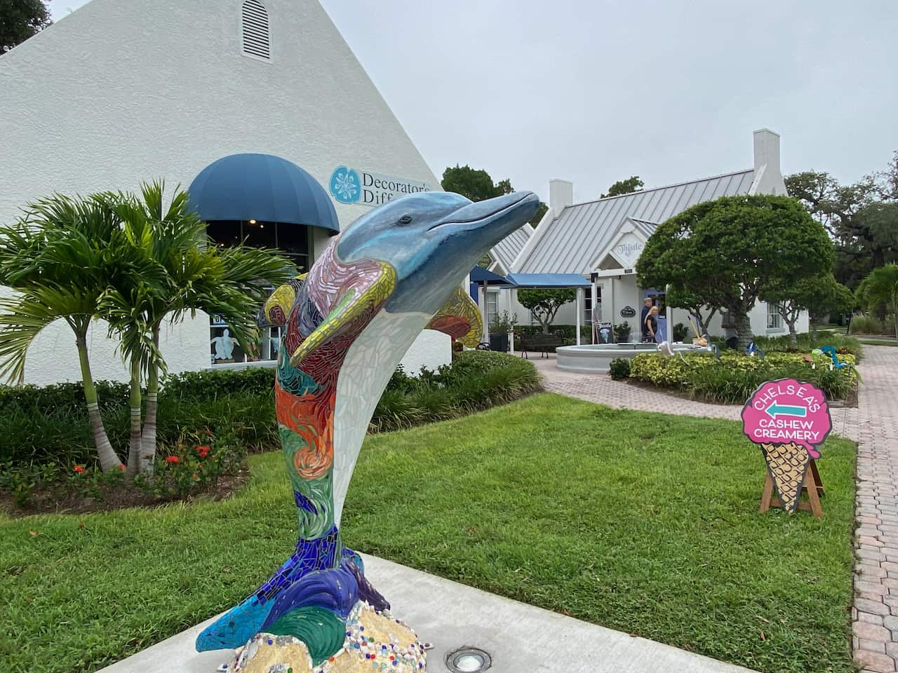 Dunedin Shops and photo of a dolphin statue outside