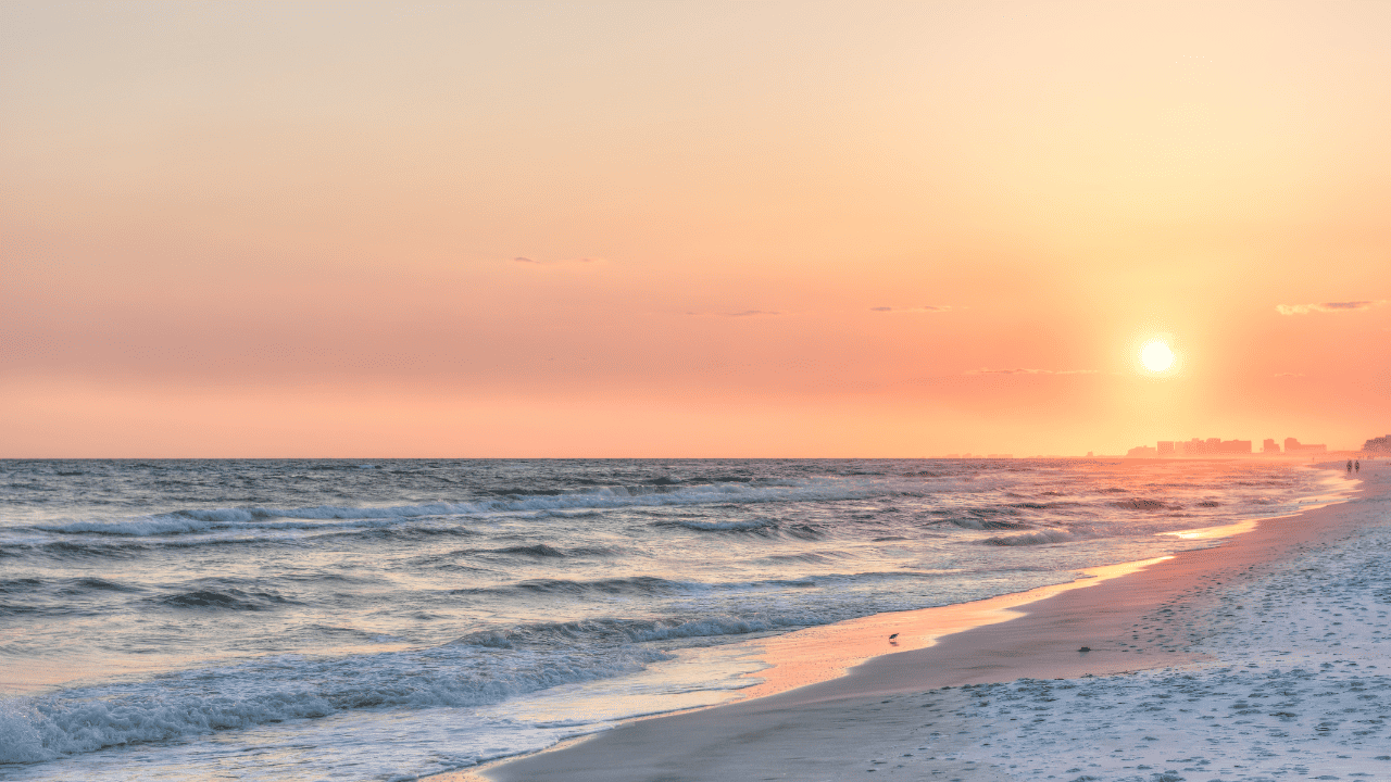 Best 30A Beaches photo at sunrise with beautiful pink peach colored sky and white sugar sand with an empty beach.