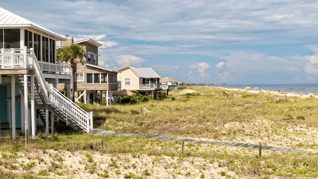 St George Beach shows beach houses and beach-goers in the distance.