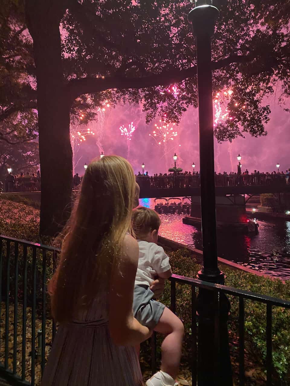 Erin and her son at Epcot watching fireworks