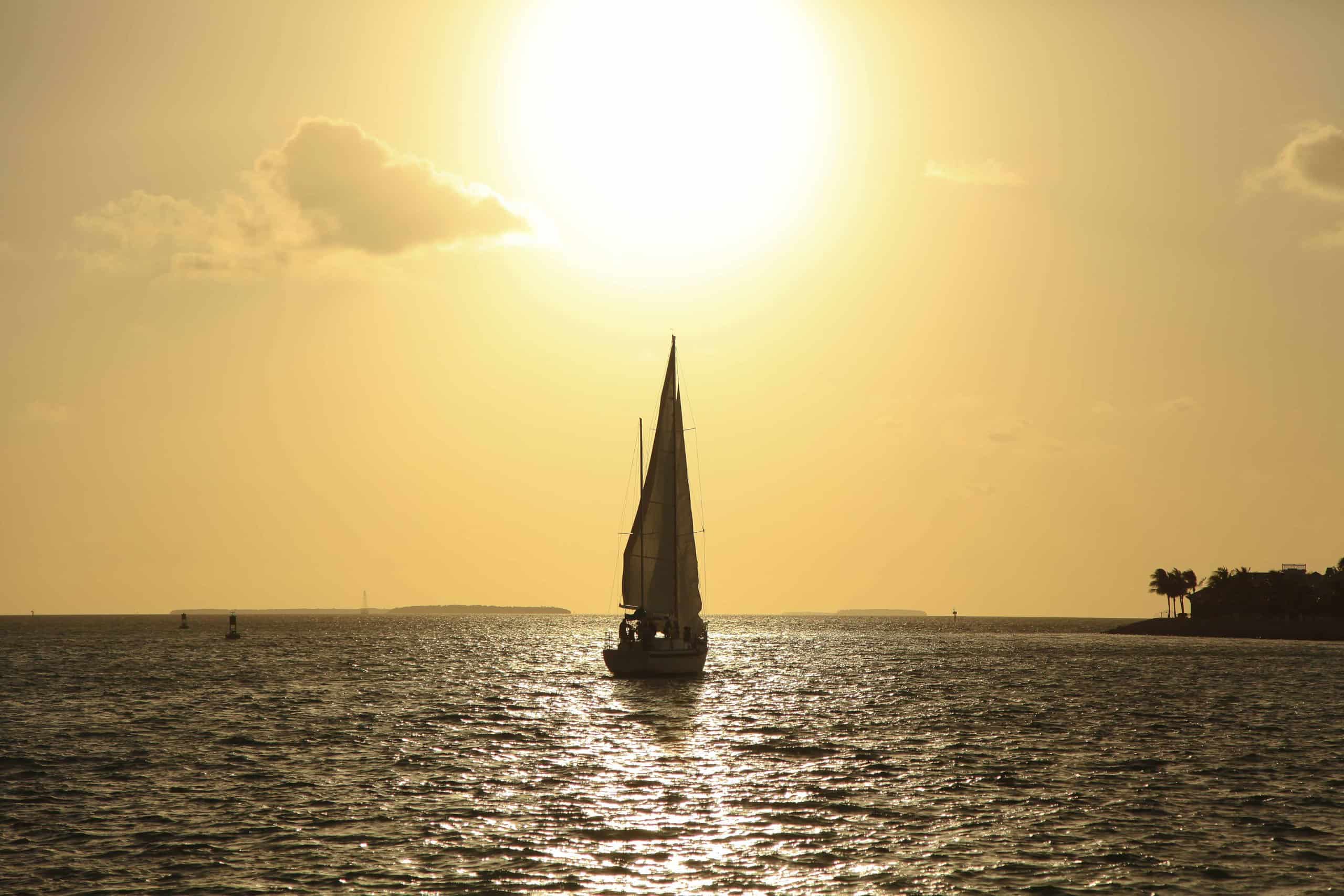 Key West sunset with a sailboat; florida weekend getaways for couples is perfect for a romantic sunset with no one around