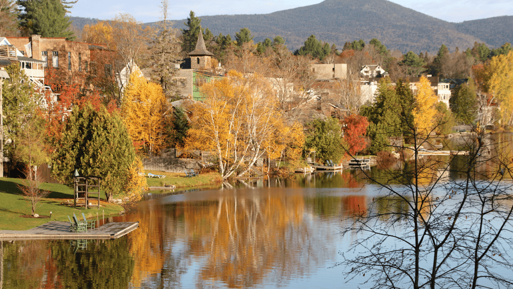 Lake George vs Lake Placid NY. Lake Placid has a beautiful view of the fall foliage overlooking the lake.