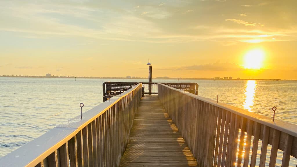 Weather in Florida in November showing a sunset on the water.