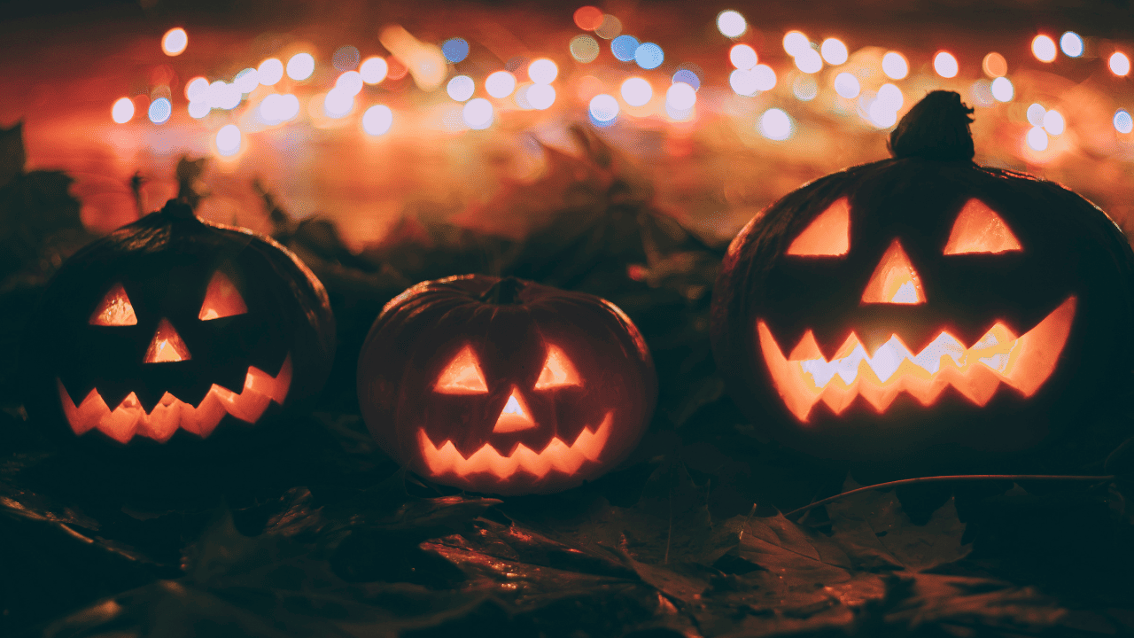 Halloween pumpkins with twinkle lights in the background