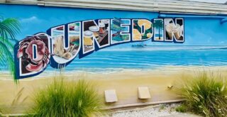 best things to do in dunedin fl article - photo of the dunedin sign near the dunedin marina